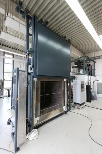 Das Bild zeigt einen Umluftofen der Firma IBT Thermprocess aus Freiberg für industrielle Anwendungen, welcher das Freiformbiegen von Glasscheiben bei Temperaturen bis 750 °C ermöglicht.